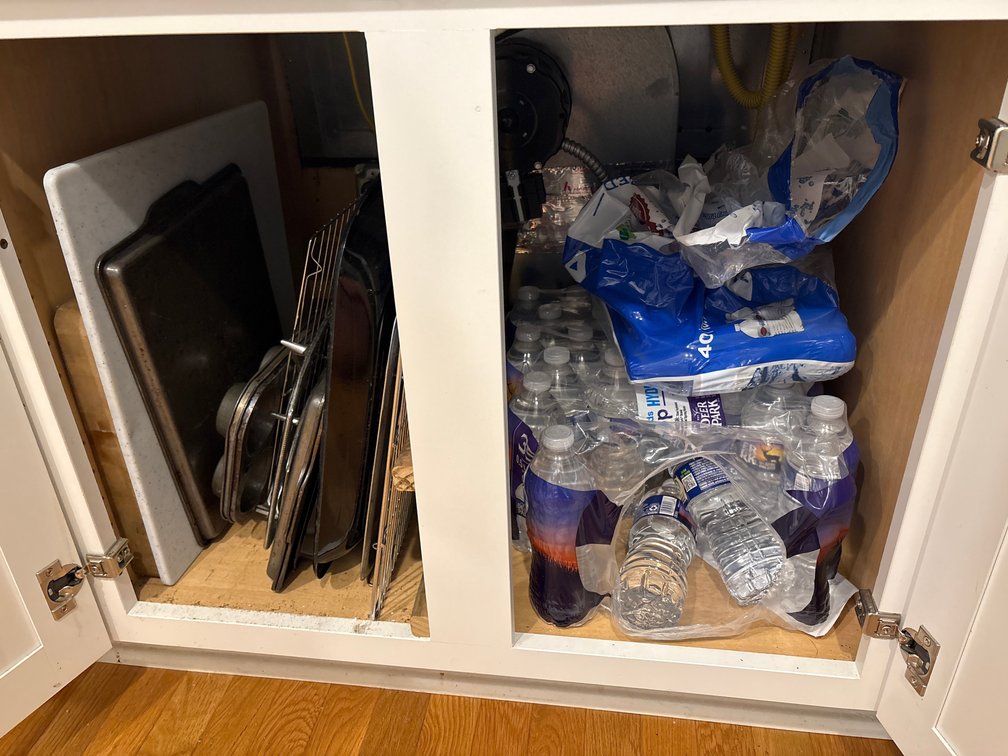 1 Cabinet contents (bottle water, cookie sheets)