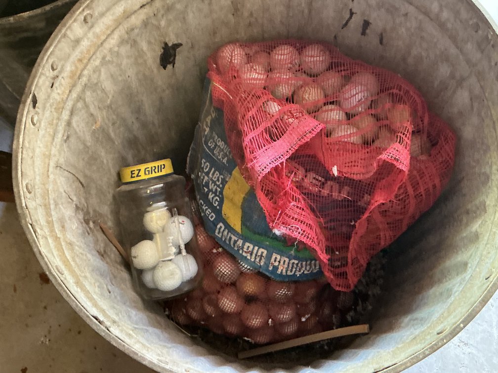 Metal Trash Can With Used Golf Balls