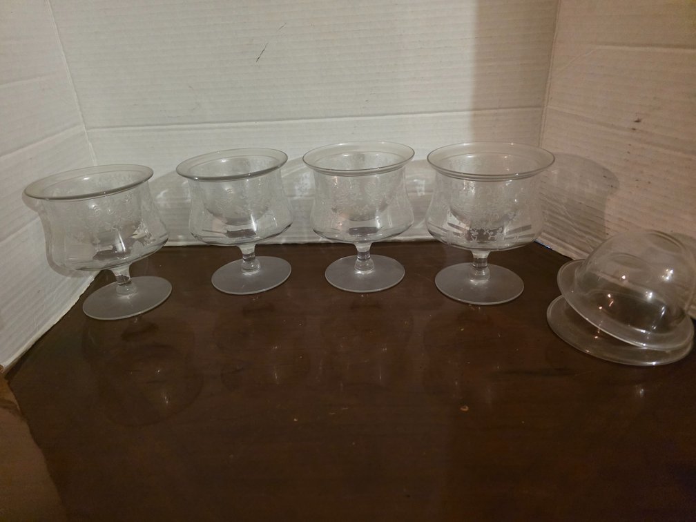 Footed crystal piece, such as a cocktail icer or shrimp cocktail glass with an etched floral design,