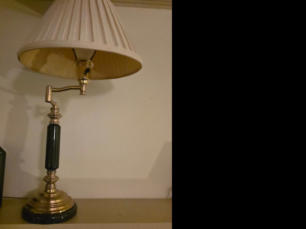 Brass and black column accent lamp with an adjustable Arm