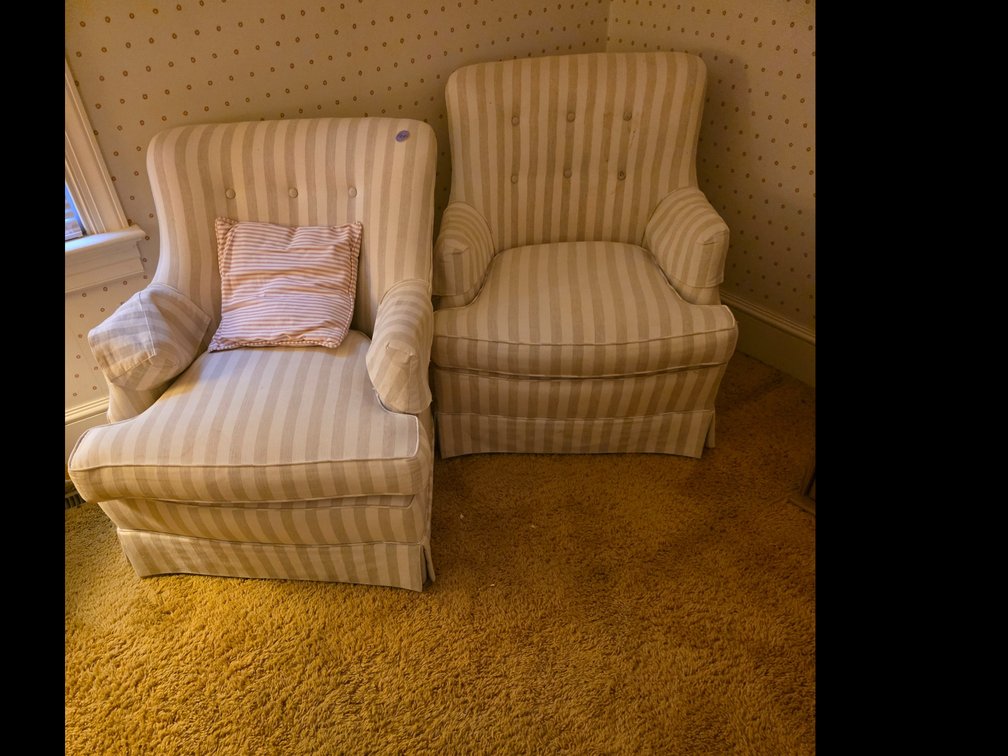 Classic ivory and beige striped upholstered armchair featuring a button-tufted back and a tailored skirted base.