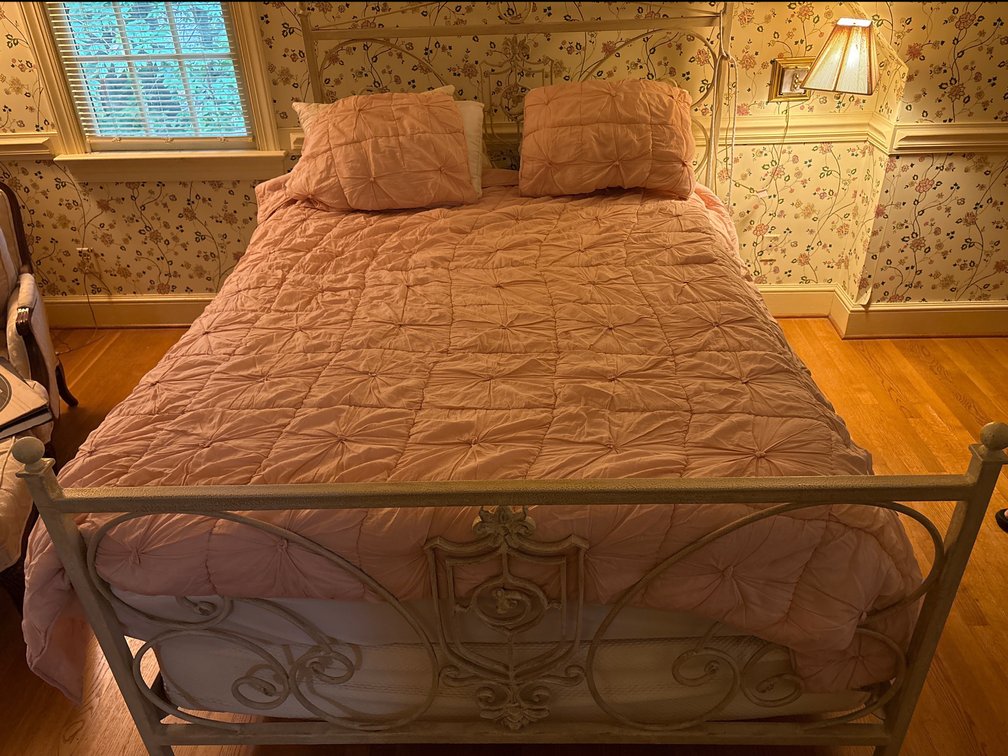 Metal Frame Bed with Ornate Scrollwork and Crest Detail
