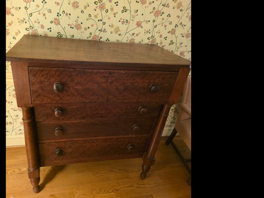 Empire- Style chest of drawers, likely crafted from cherry wood with turned columns and round wooden knobs,  Solid Wood