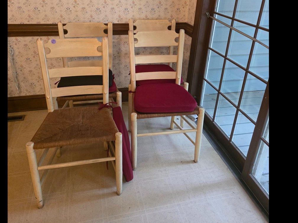Vintage painted ladder-back wooden dining chair featuring a woven rush seat.