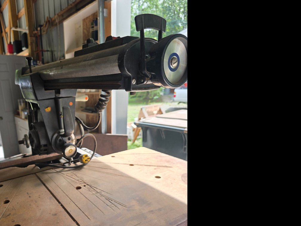 Craftsman 10-inch radial arm saw mounted on a matching metal cabinet base
