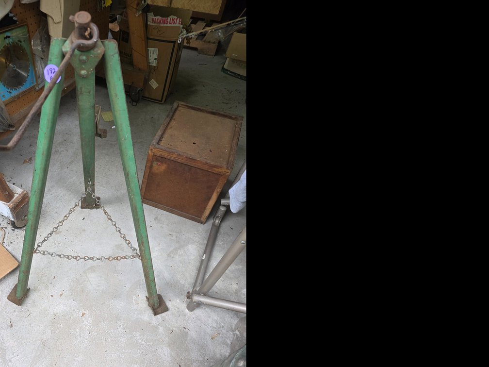 Vintage tripod screw-type bumper jack with a hand crank.