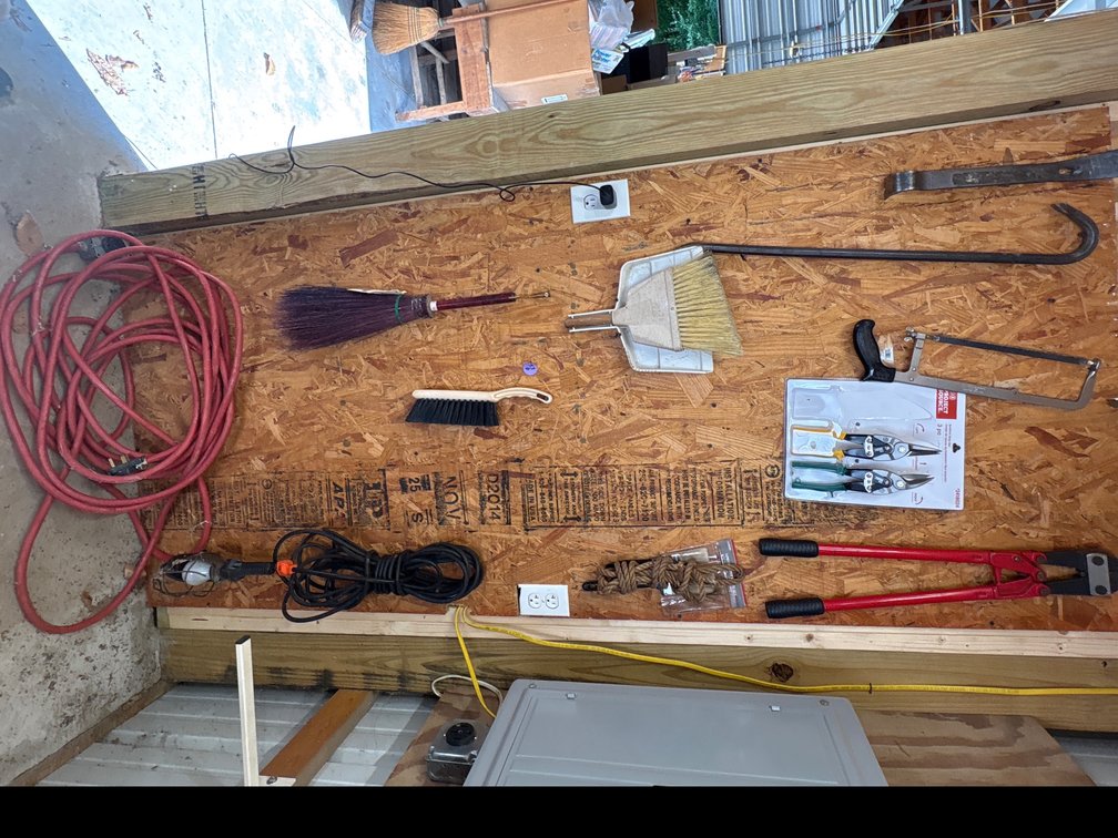 Items mounted and hanging on the wooden shelf
