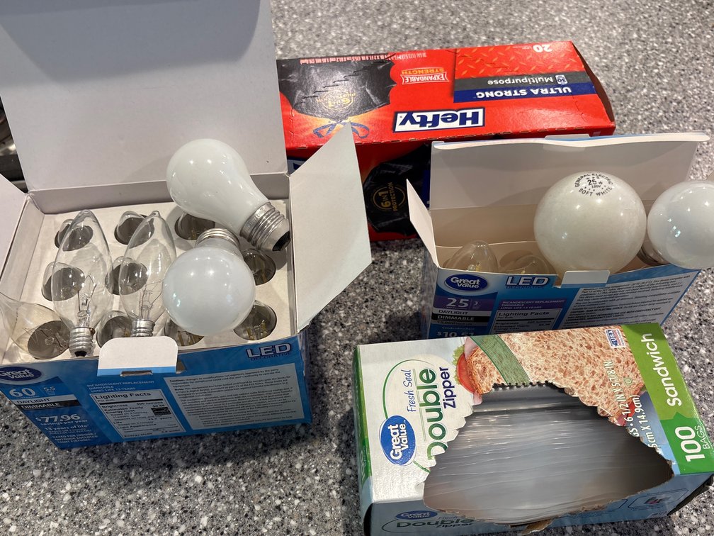 Miscellaneous lightbulbs, trash bag, zipper bags