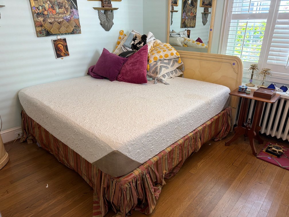 King size bed with headboard and linens