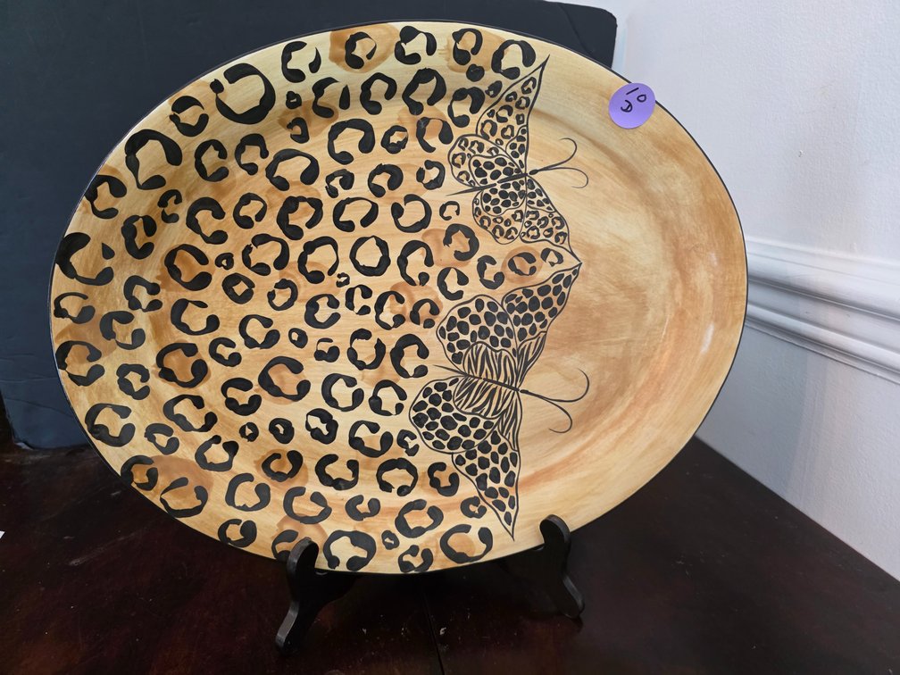 Mikasa Metamorphosis pattern designed by Laurie Gates, showcasing a bold leopard print accented with detailed black butterfly motifs.