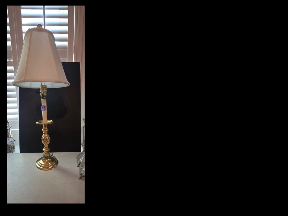 Classic polished brass candlestick table lamp featuring a twisted stem design and a white flared empire shade