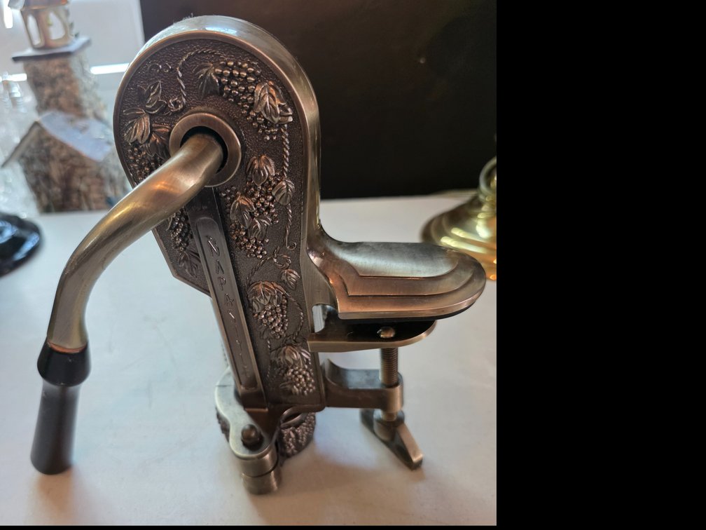 Napa Style , wine bottle opener and corkscrew, featuring an ornate embossed grapevine design and an adjustable table clamp