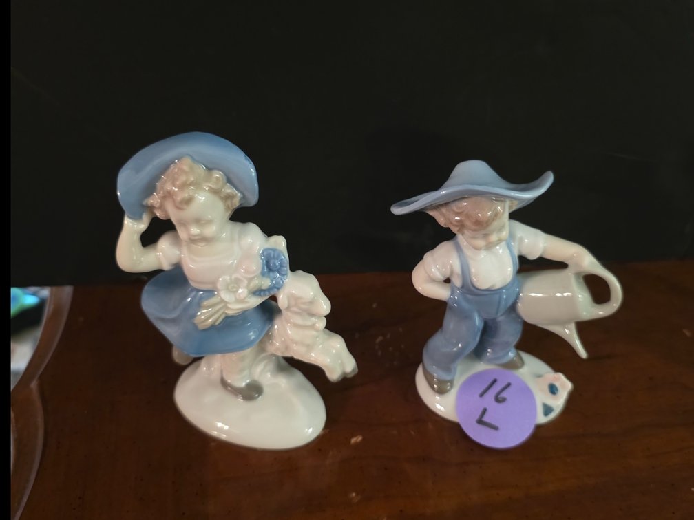 Vintage 1960s porcelain figurine of a young girl with a lamb and flowers,  manufactured by Wagner & Apel in Lippelsdorf, East Germany (GDR).vintage porcelain figurine of a young boy in blue overalls and a wide-brimmed hat holding a watering can: