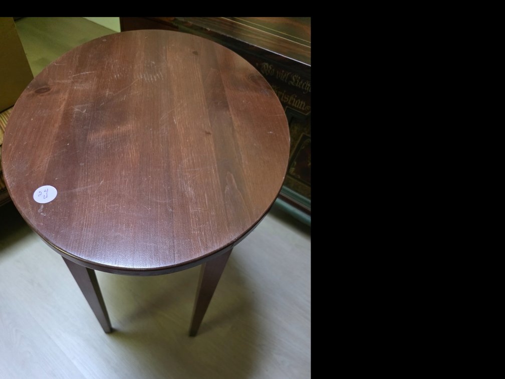 Dark wood accent table with an oval tabletop and tapered legs.