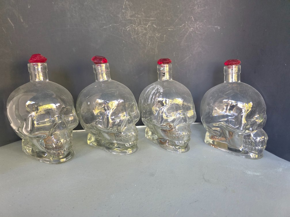 Clear glass skull-shaped bottle resembling a Crystal Head Vodka bottle