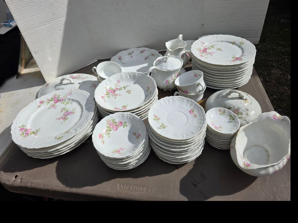 Porcelain dinnerware service featuring a white scalloped base with pink floral and rose decals