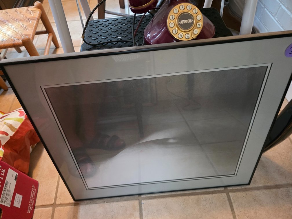 Black-framed matted picture with a neutral or abstract photographic print