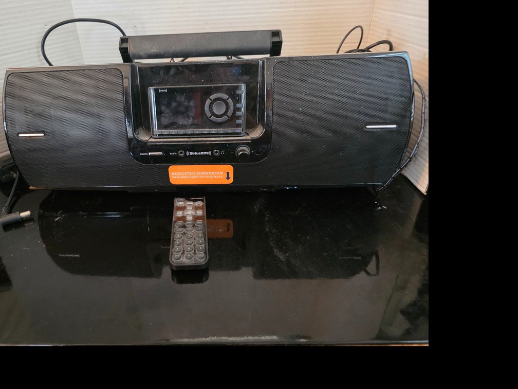SiriusXM Onyx EZ satellite radio receiver docked inside a portable audio speaker dock