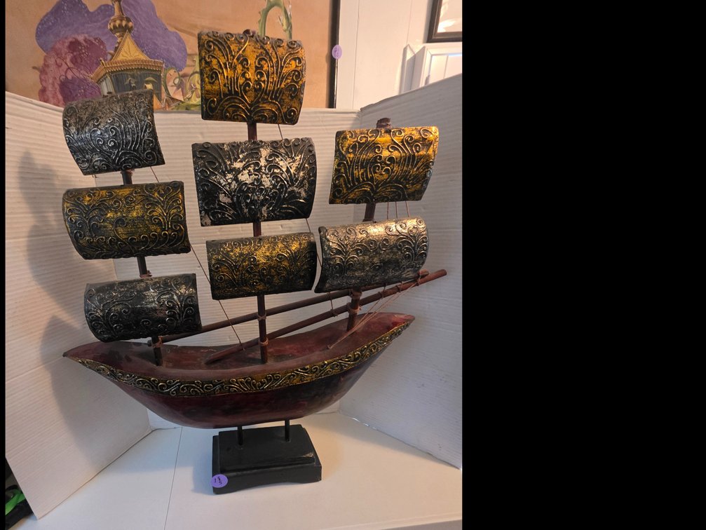 Decorative  Wood tabletop model of a sailing ship featuring a reddish-brown hull with gold-colored trim and textured,