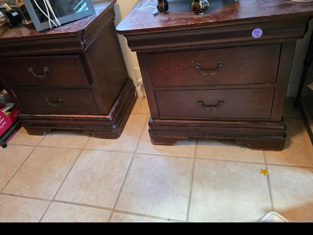 Two-drawer nightstand features a rich dark wood finish paired with traditional antique-style metal  Pulls