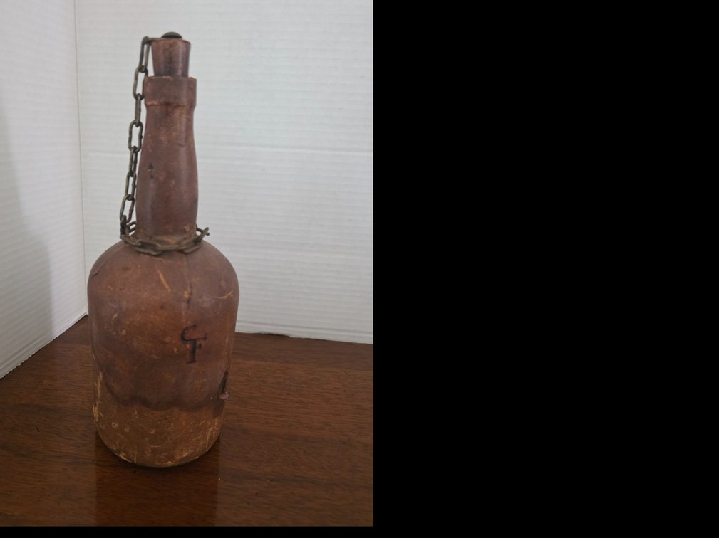 Vintage leather-wrapped glass decanter or liquor flask