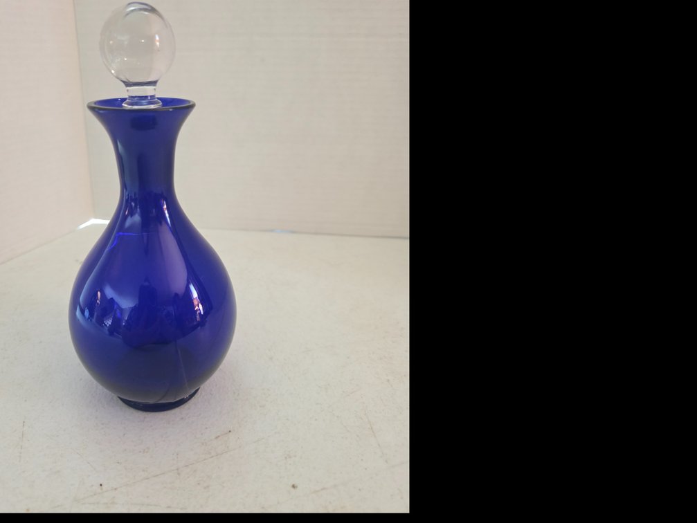 Vintage cobalt blue glass decanter with a rounded body, a narrow neck,