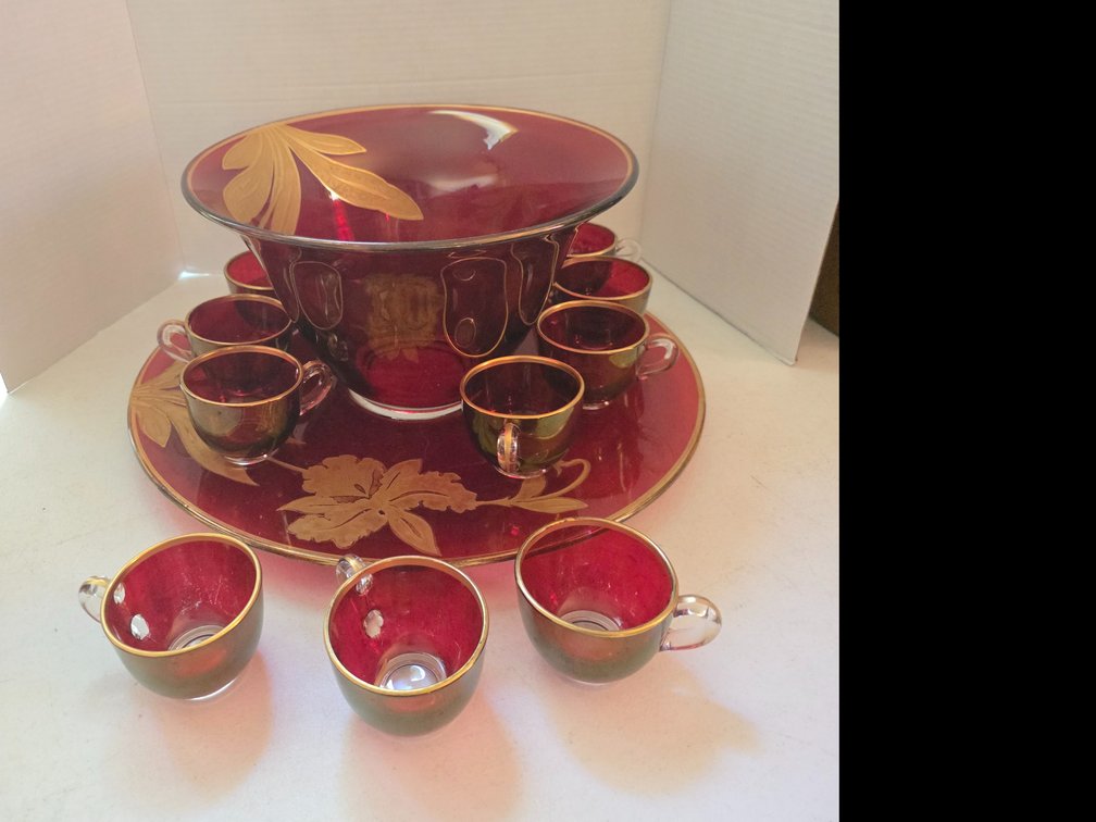 Vintage ruby red (cranberry) glass punch bowl or berry set with hand-painted or flashed gold leaf floral and leaf motifs, complete with a matching large underplate/tray , Cups