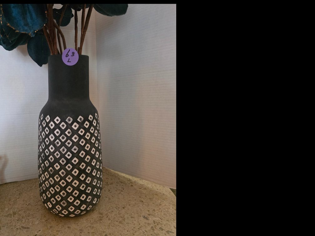 Decorative black vase featuring a textured white geometric diamond pattern