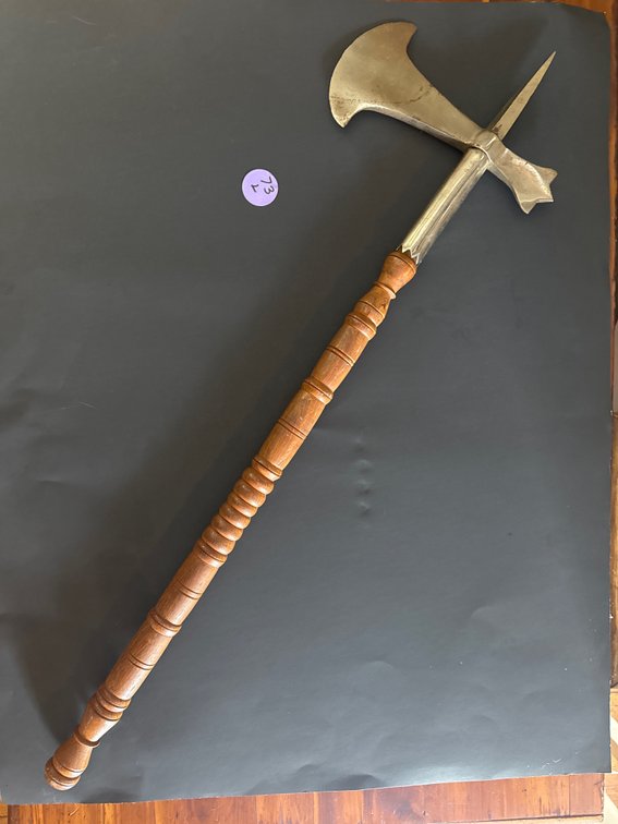 Medieval-style battle axe featuring a curved metal blade, a rear spike, and a turned wooden shaft with a spiral grip.  decorative and historical-replica pieces  30”x 9”