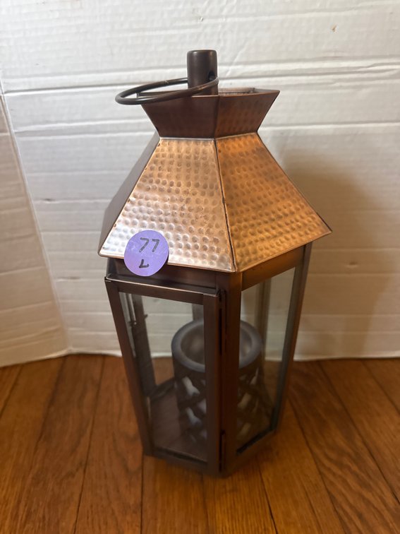 Antique-style metal candle lantern featuring a hammered copper-finish top roof