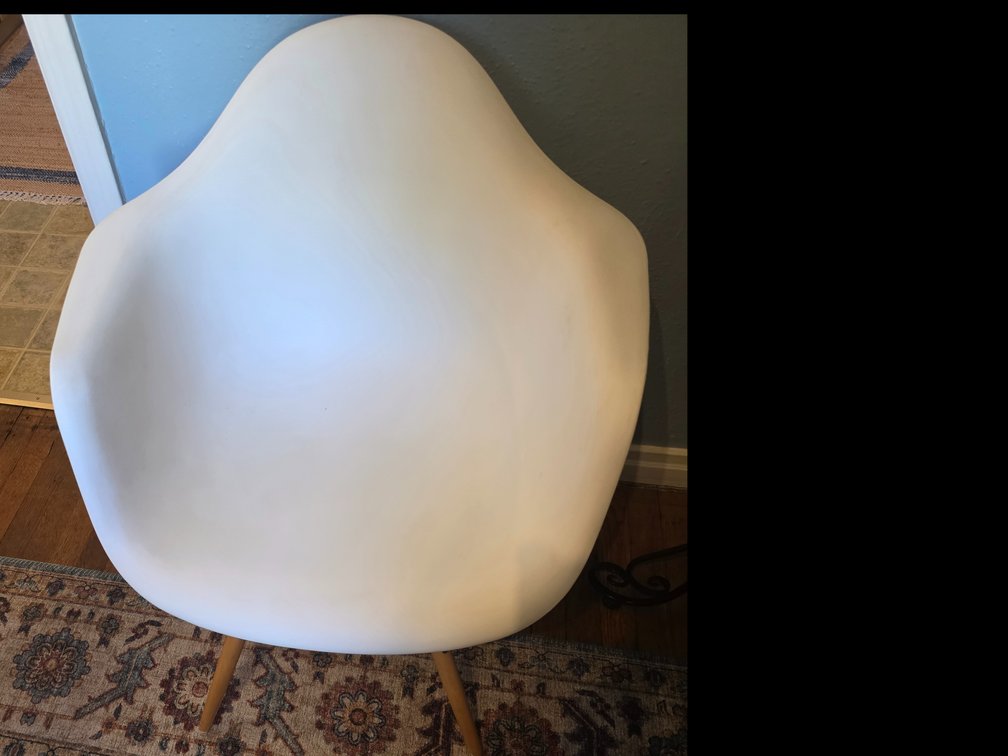 White mid-century modern style molded plastic armchair
