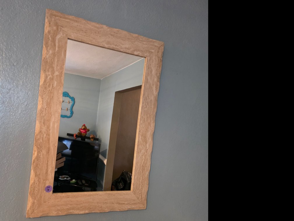 24-in W x 36-in H Travertine  Wall Mirror, featuring a handcrafted textured stone frame with scalloped edges