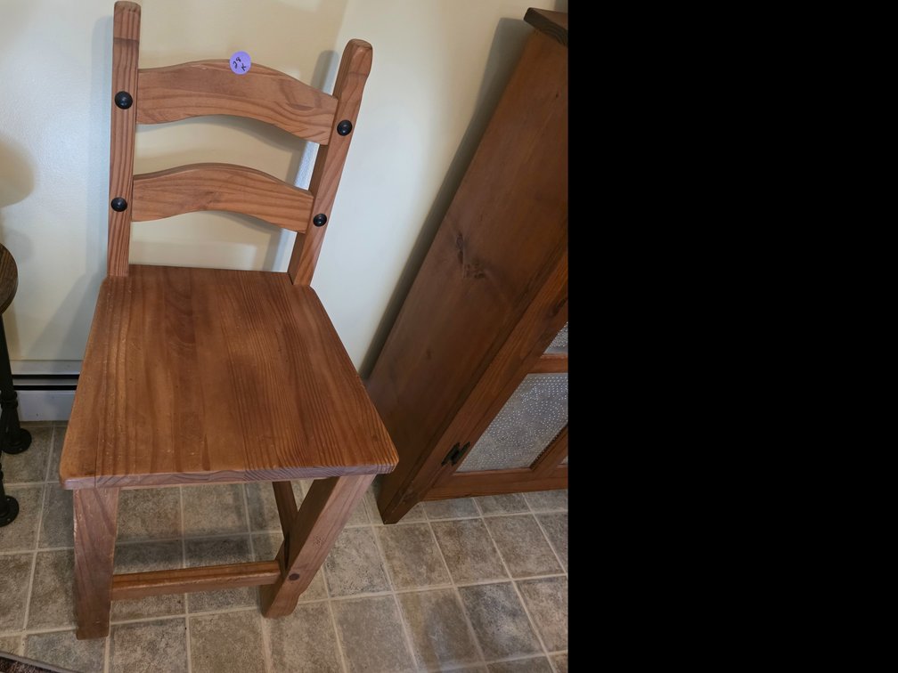 Rustic solid pine ladder-back barstool or counter-height chair featuring dark metal rivet accents.