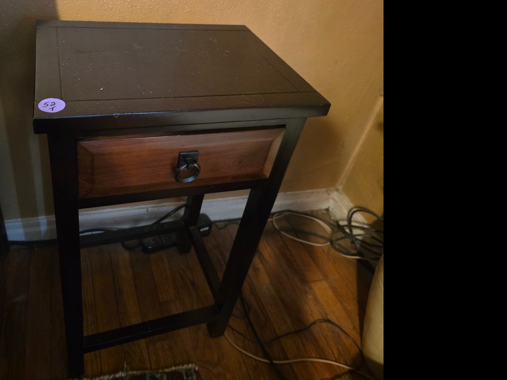 Dark accent  table  mission-inspired design with a contrasting natural wood-tone drawer front, a single drawer with a round ring pull