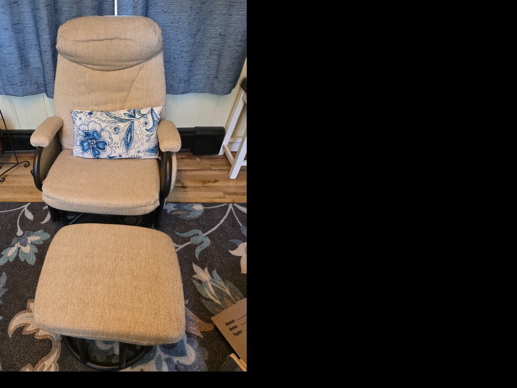 Beige upholstered swivel glider recliner and matching ottoman set, closely