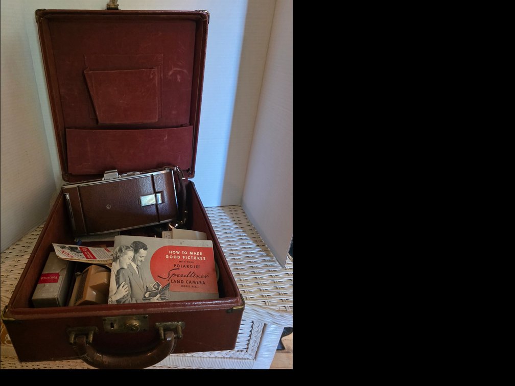 Vintage Polaroid Speedliner Land Camera Model 95A with its original leather case and manual.
