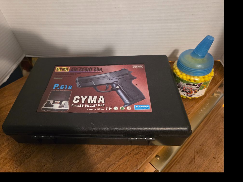 CYMA P.618 6mm spring-powered airsoft pistol packed inside a black hard case
