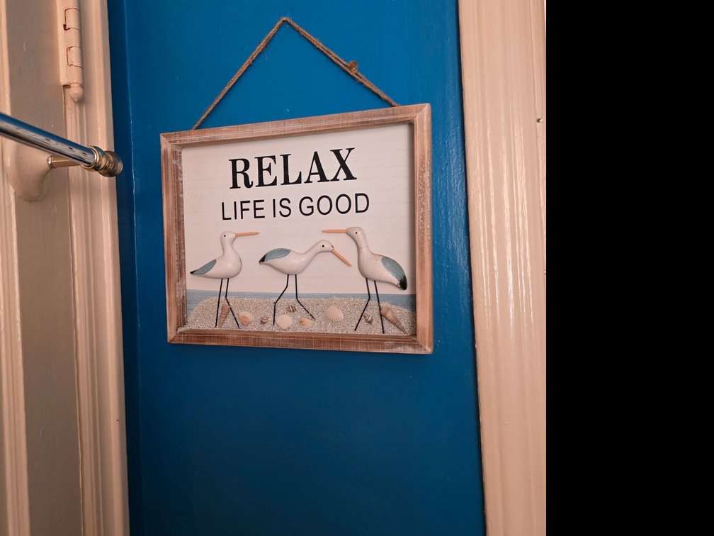 Contents of Bathroom   Towels     wall Decor   , Green Storage Bench