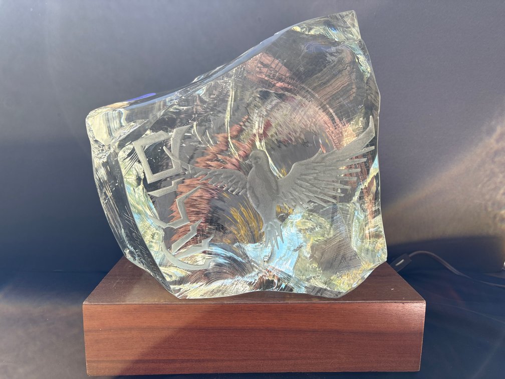 Signed cast glass art sculpture on an illuminated wooden base