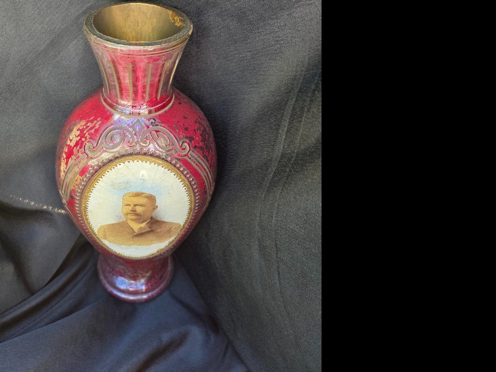 Victorian-style cranberry (ruby) glass portrait vase featuring a central oval medallion with a man's portrait.