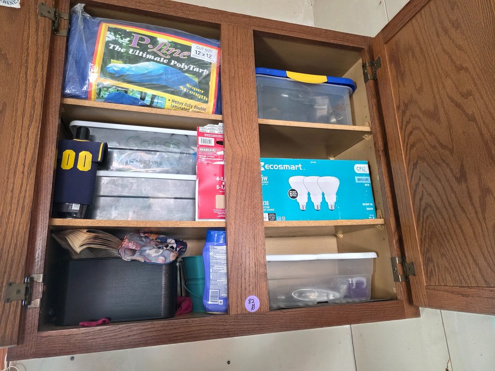 Contents  of 2 upper cabinets, Tarp,Light Bulbs,Etc