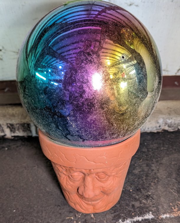 Terra Cotta Planter w/Face Design & Iridescent Glass Globe