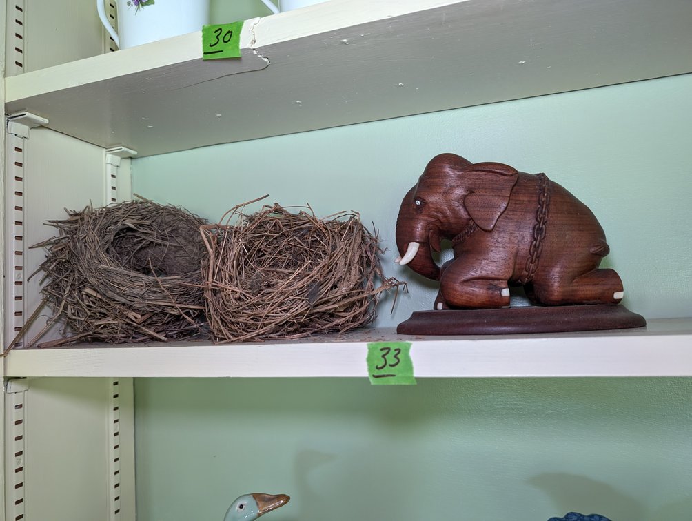 Hand-Carved Wooden Kneeling Elephant Figurine on Base and Birds Nests
