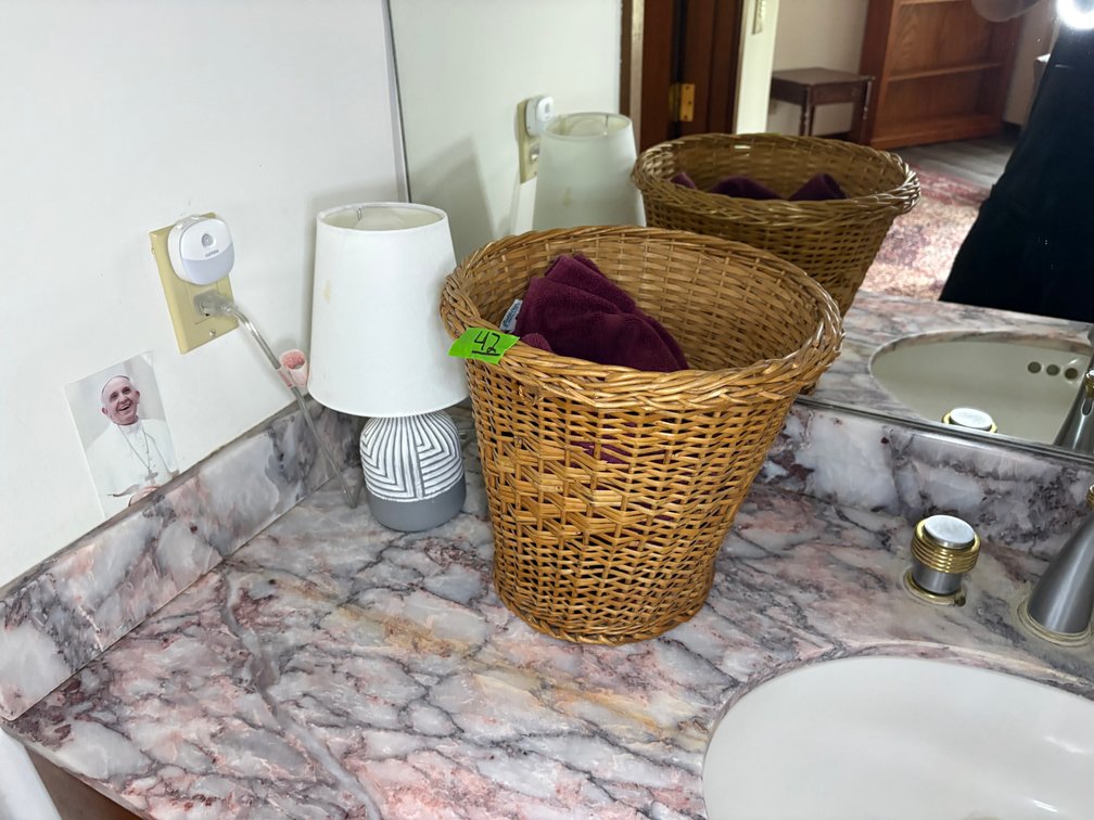 Woven Wicker Basket with Linens and Modern Ceramic Table Lamp