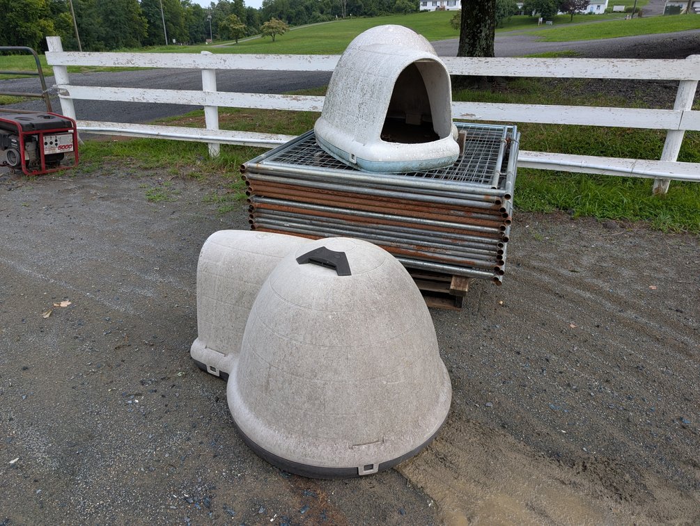 Stack of Metal Dog Fence Gates with (2) Plastic Dogloo Igloo Dog Houses