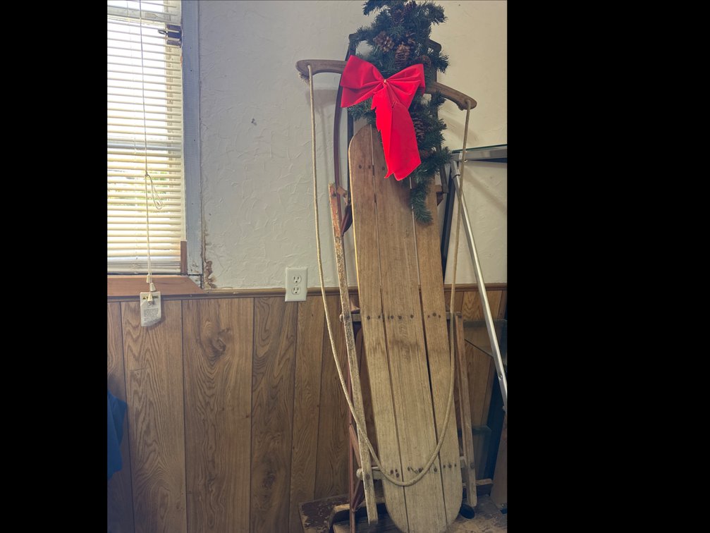 Vintage Wooden Snow Sled with Red Metal Runners and Holiday Greenery