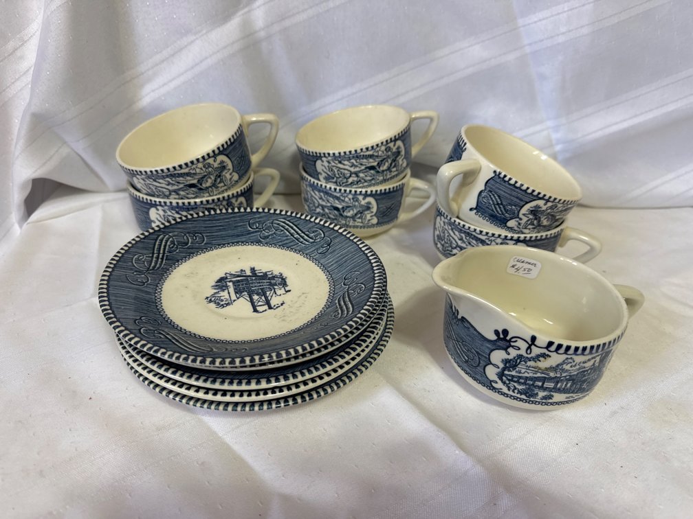Blue and White Transferware Ceramic Teacups, Saucers, and Creamer (11 Pieces)