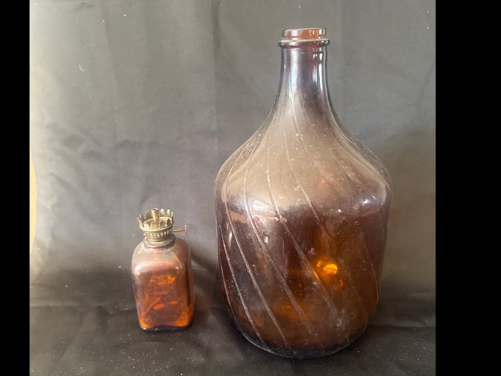 Amber Glass Spiral-Ribbed Bottle and Miniature Oil Lamp