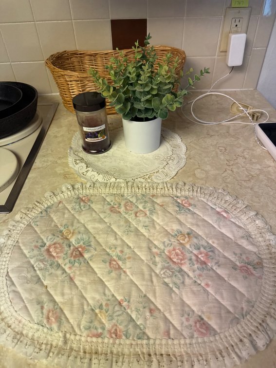Kitchen Decor Items Featuring Basket, Mat, Faux Plant, and Candle