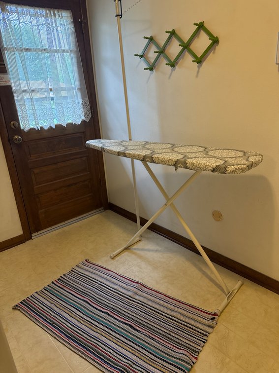 Folding Ironing Board, Striped Rug, and Expandable Green Wall Rack